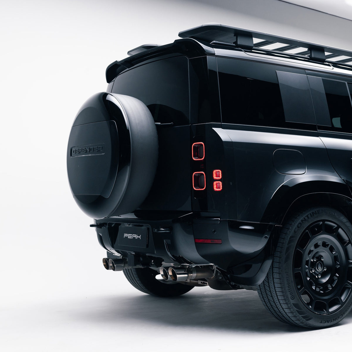Land Rover Defender 110 rear three-quarter view with Gloss Black rear bumper corner trims