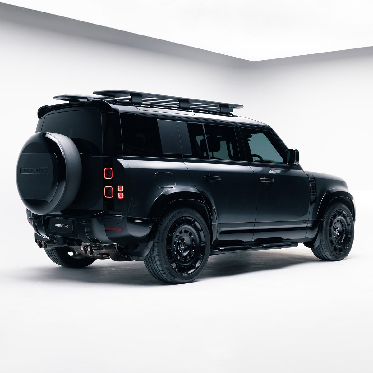 Land Rover Defender 110 with Gloss Black Exterior Styling Pack, rear three-quarter view
