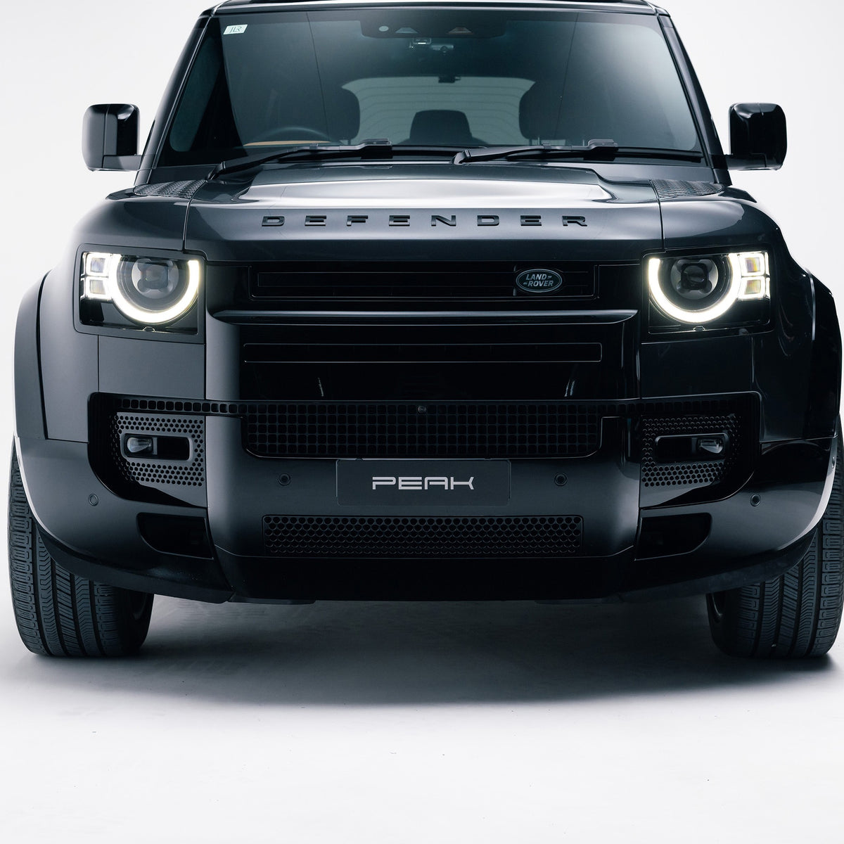 Gloss Black front bumper trim fitted to a Land Rover Defender 110, front view