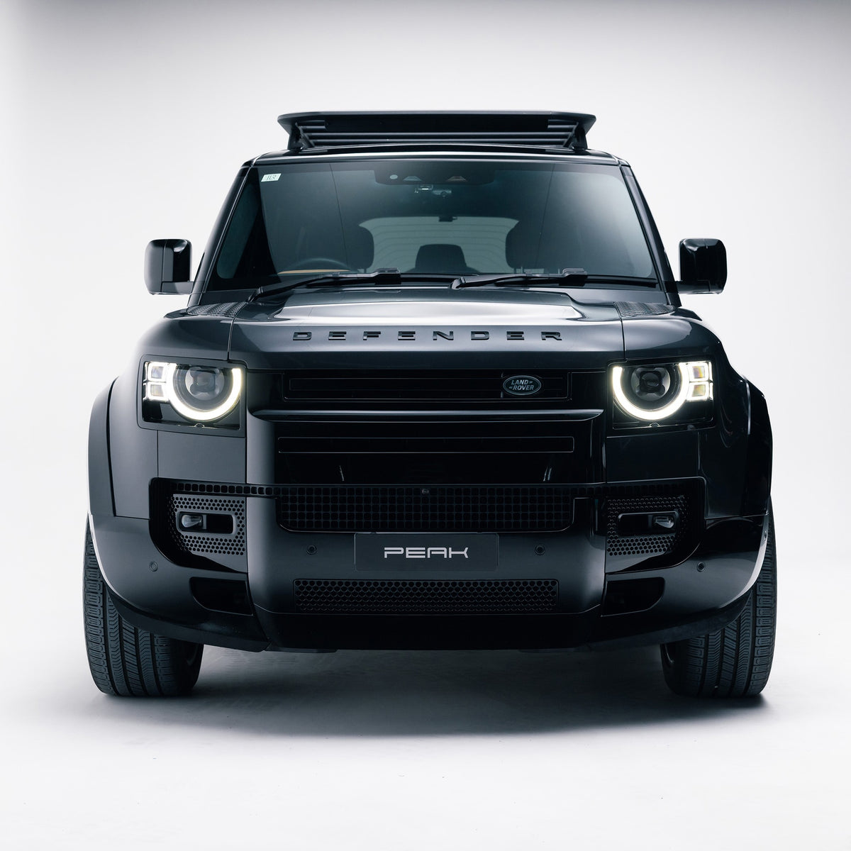 Land Rover Defender 110 front view with Gloss Black front grille trim