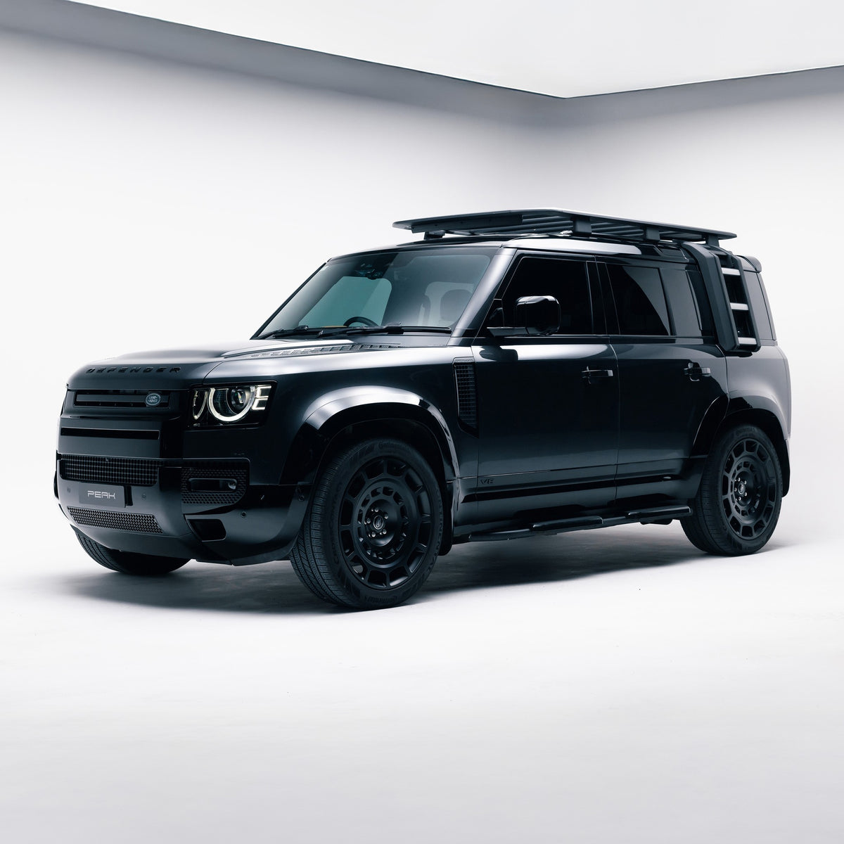 Land Rover Defender 110 front three-quarter view with Gloss Black door mouldings