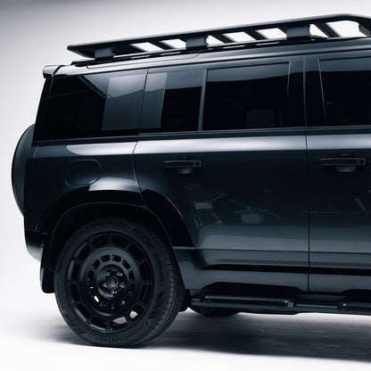 Land Rover Defender 110 rear side view showing Gloss Black door mouldings