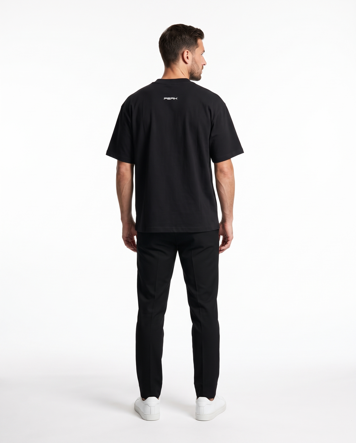 PEAK Back Neck Tee in Black, back view of the small wordmark under the collar