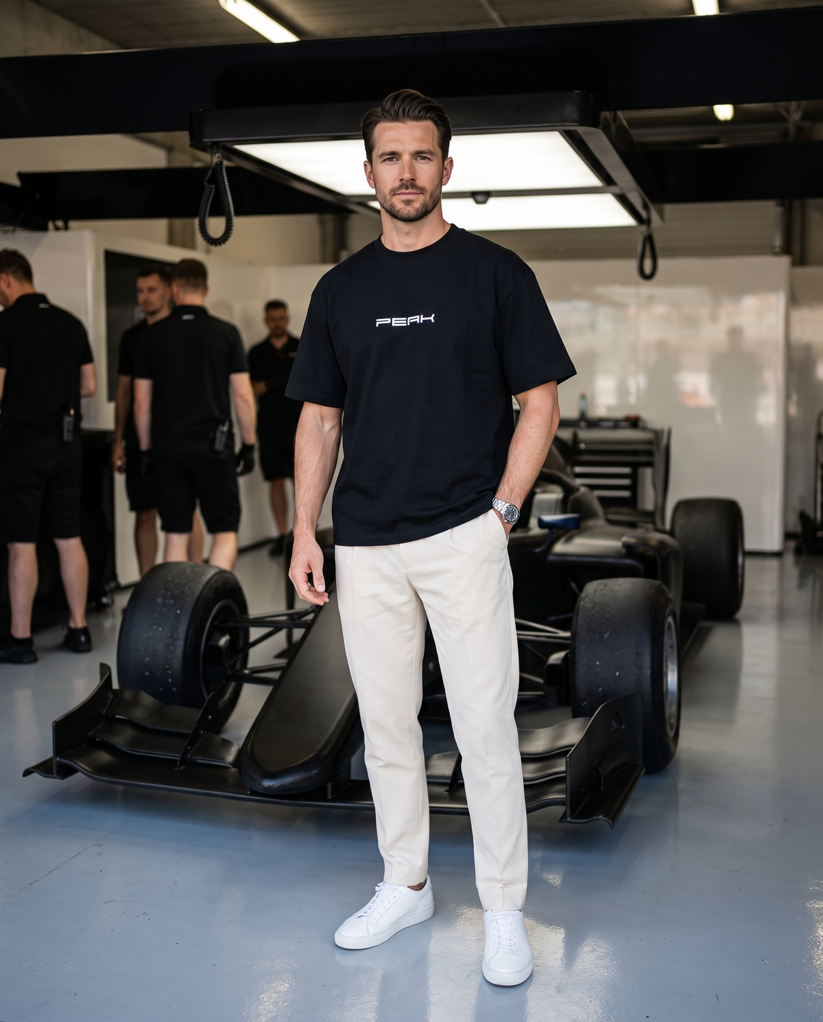 PEAK Heavy Tee in Black, worn in a race team pit garage
