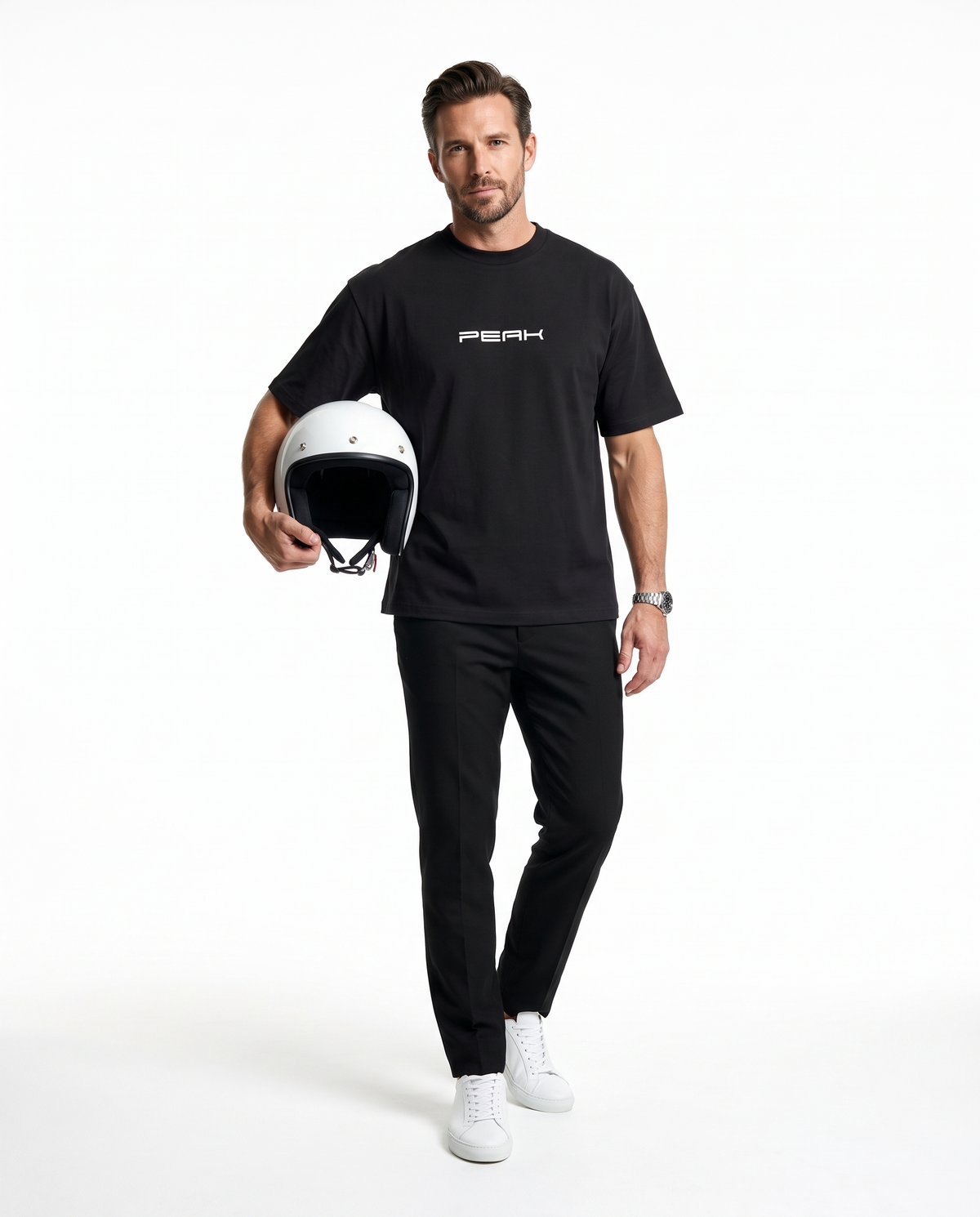 PEAK Heavy Tee in Black, worn with a white racing helmet in hand