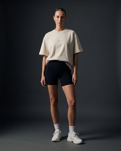 PEAK Tonal Tee in Ecru with a sand chest wordmark, worn by a woman